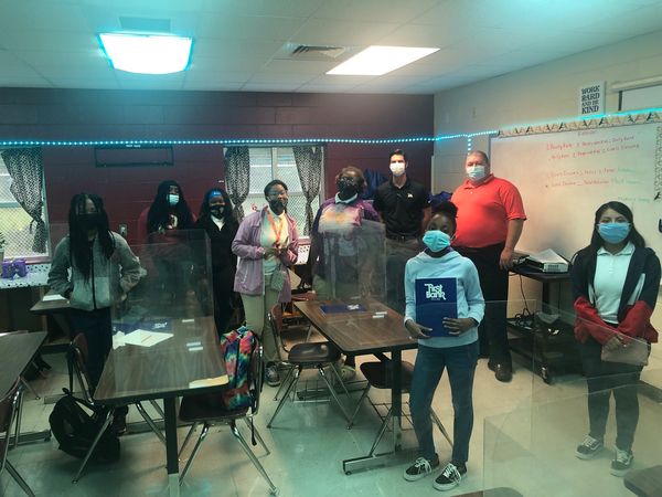 First Bank employees in Burger Middle School classroom in Hattiesburg, MS.