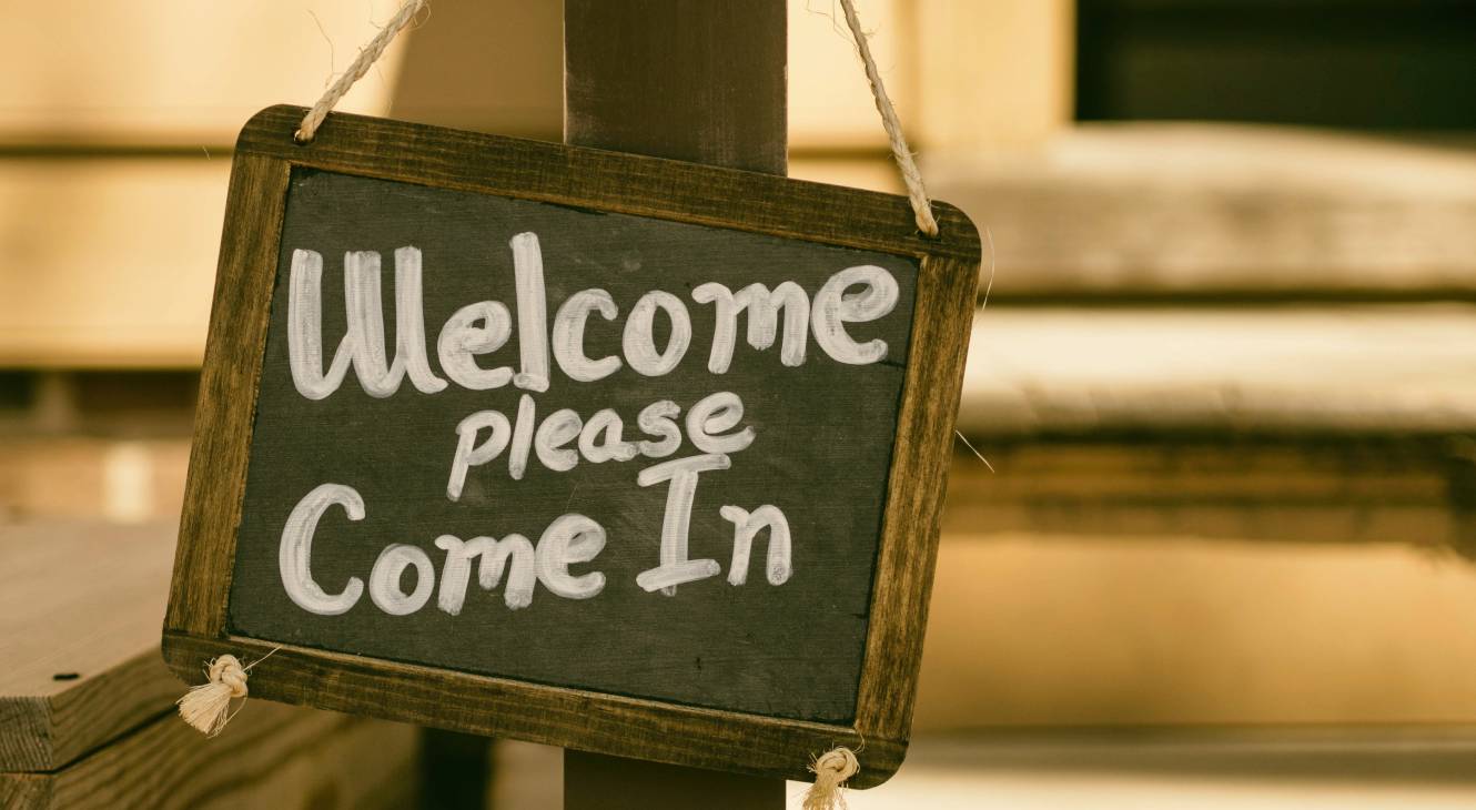 Chalkboard sign with "Welcome Please Come In" in a "crafty styling".