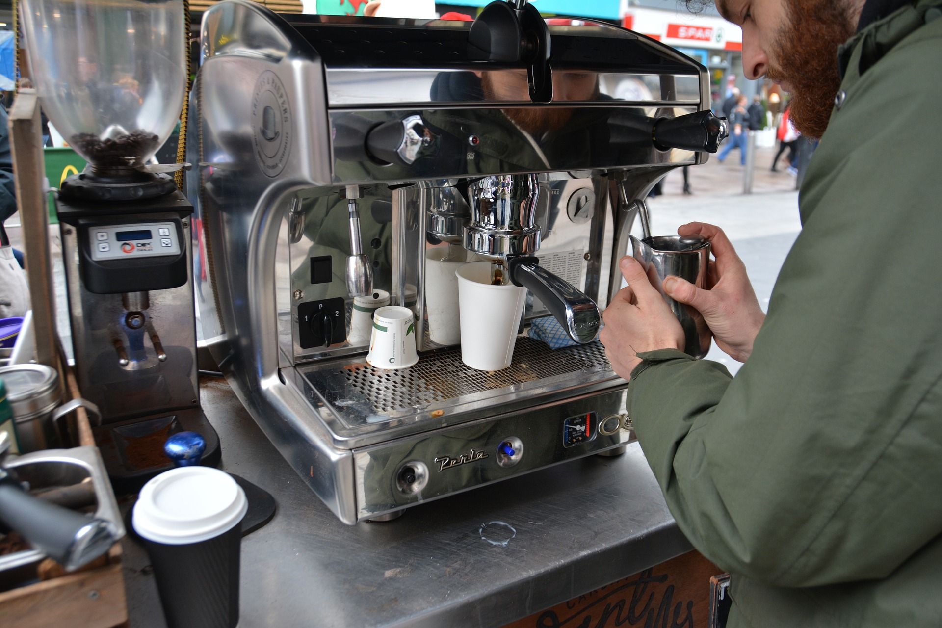 Coffee barista preparing cups in a coffee shop.